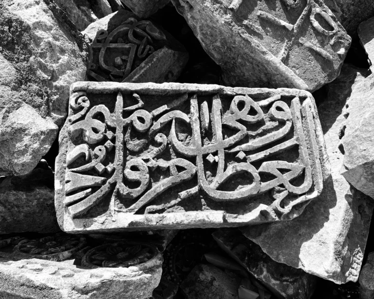 Traditional Arabic calligraphy pen merging with AI robotic hand creating Arabic script art, symbolizing technology and heritage.